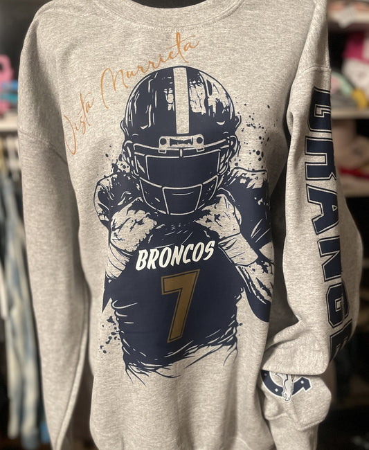 Grey embroidered crewneck with Broncos helmet graphic and name on the sleeve