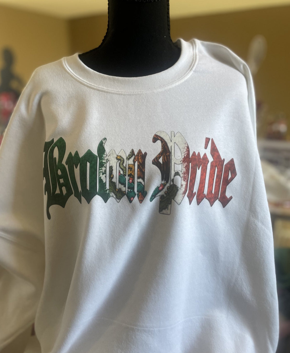 White crewneck with Brown Pride lettering