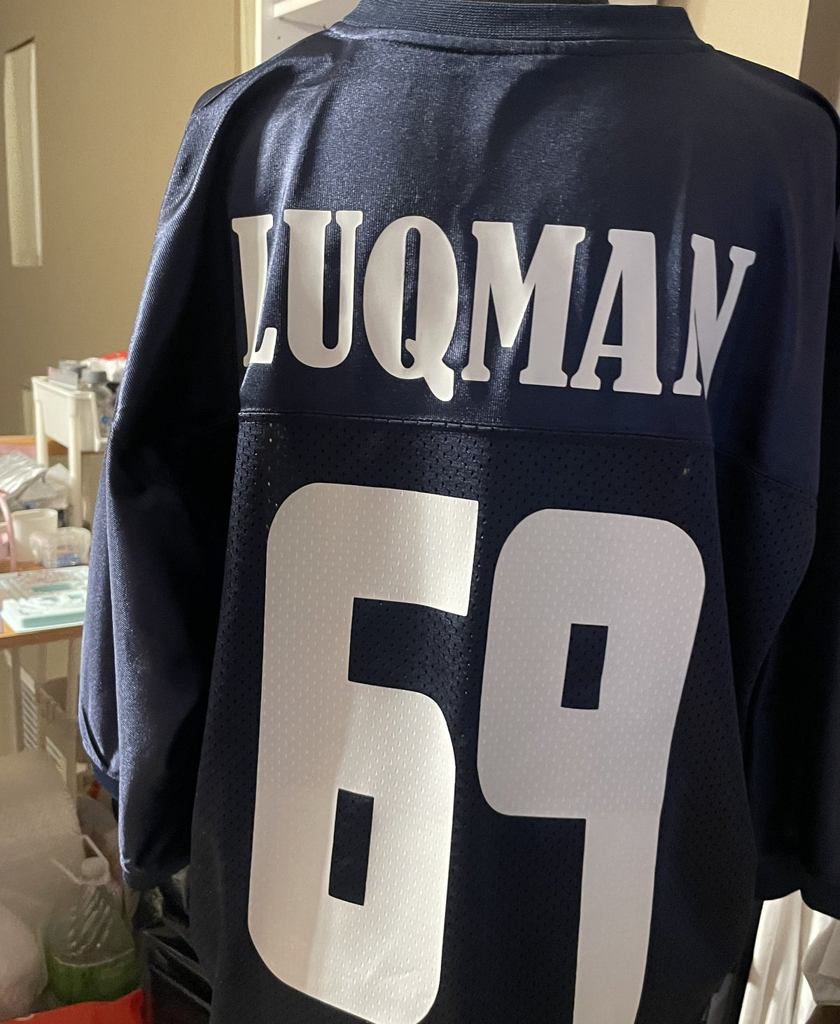 Custom navy football jersey with Luqman and number 69