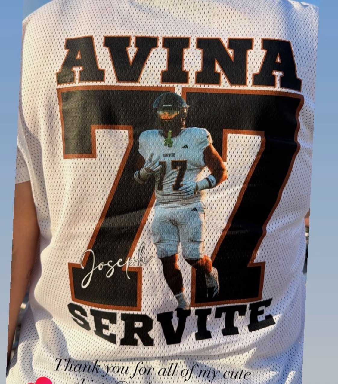 White sports jersey with Avina number 77 Servite and a photo of the athlete